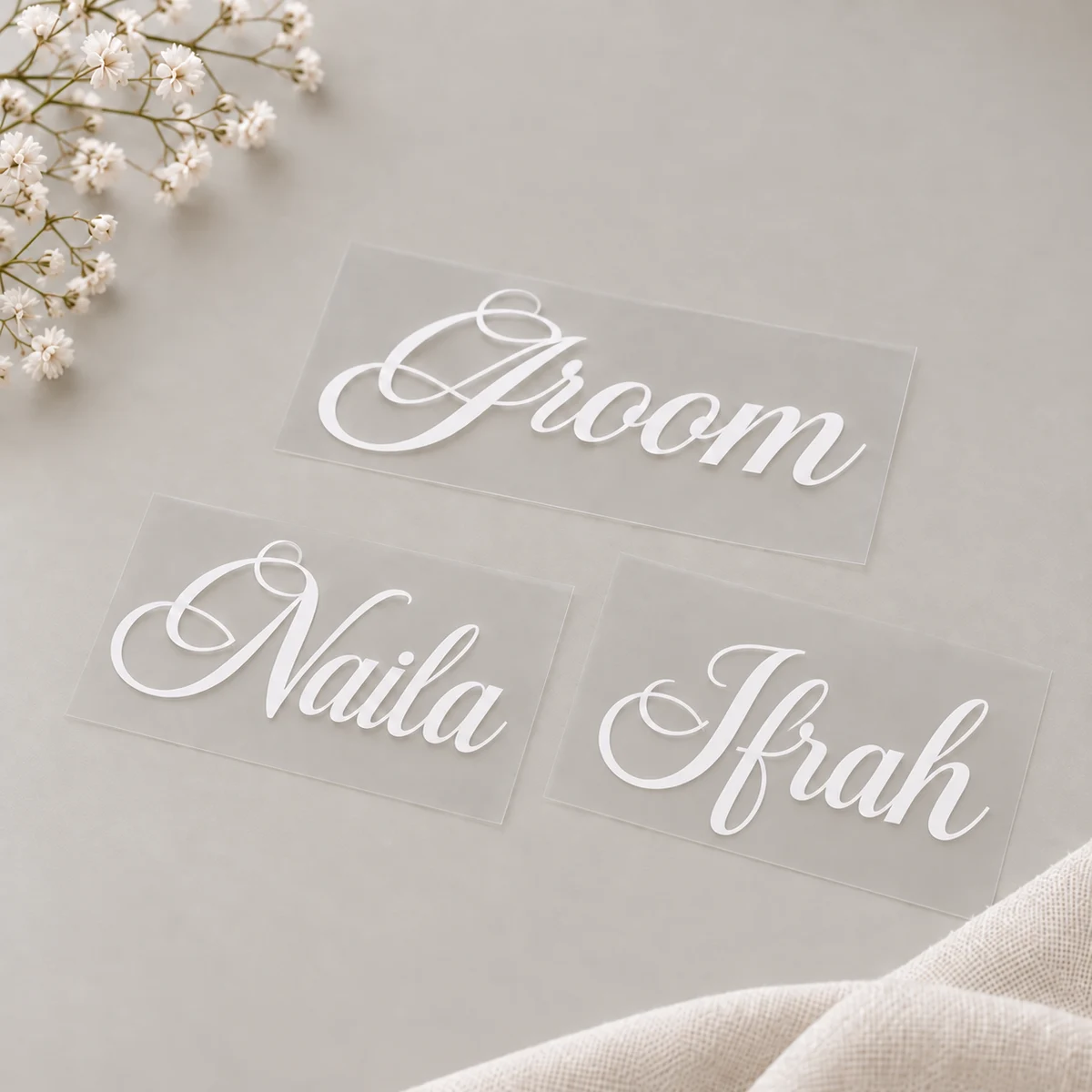 White personalised vinyl lettering displayed on a neutral background
