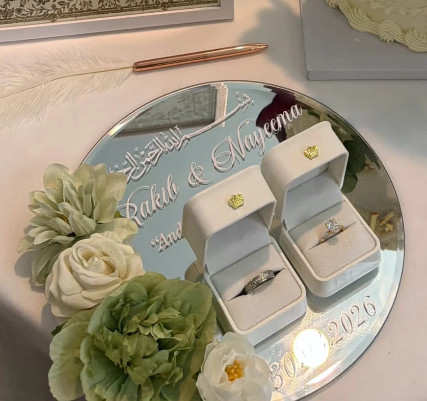 Ring plate vinyl lettering shown on a mirrored display with rings and flowers